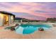 Custom pool and spa with a view at sunset in the backyard at 211 Granite Ct, Boulder City, NV 89005