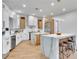 Modern kitchen with marble island, light wood cabinets, and stainless steel appliances at 211 Granite Ct, Boulder City, NV 89005