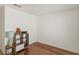 Bedroom with wood floors, white walls, and simple furnishings at 2112 Spanish Town Ave, North Las Vegas, NV 89031