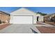 One-story home with attached two-car garage and desert landscaping at 2112 Spanish Town Ave, North Las Vegas, NV 89031