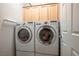 Laundry room with LG washer and dryer, and wood cabinets at 2429 Great Auk Ave, North Las Vegas, NV 89084