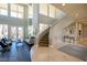 Spacious living room with a curved staircase and hardwood floors at 249 E Eldorado Ln, Las Vegas, NV 89123