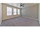 Spacious bedroom with ceiling fan, grey walls, and grey carpeting at 2555 Hampton Rd # 3206, Henderson, NV 89052