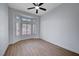 Bright bedroom with bay windows, wood-look flooring, and a ceiling fan at 2605 High Range Dr, Las Vegas, NV 89134