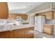 Kitchen with wood cabinets, island, and tile floor at 2701 Rising Legend Way, Las Vegas, NV 89106