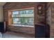 Living room with wood-paneled walls and large window overlooking the backyard at 321 Simon Bolivar Dr, Henderson, NV 89014