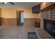 Living room with a fireplace, wood paneling, and tile floor at 321 Simon Bolivar Dr, Henderson, NV 89014