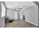 Grey bedroom with wood-look floors and access to bathroom at 325 N Minnesota St, Las Vegas, NV 89107