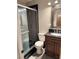 Bathroom featuring a shower, toilet, and dark wood vanity at 3660 Timberlake Dr, Las Vegas, NV 89115