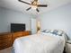 Cozy bedroom with double bed, dresser, and ceiling fan at 4259 Chocolate St, Las Vegas, NV 89122