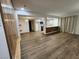 Open living room with kitchen view, wood-look floors at 4981 River Glen Dr # 63, Las Vegas, NV 89103