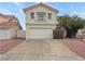 Front view of a two-story home with attached two-car garage and driveway at 504 Landra Ln, Henderson, NV 89015