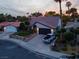 Single-story house with a two-car garage and well-manicured front yard in a residential neighborhood at 5163 Rudy Ln, Las Vegas, NV 89120