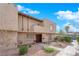 Two story tan townhome with walkway, landscaping, and a private entrance at 6263 W Washington Ave, Las Vegas, NV 89107