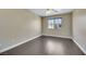 Empty bedroom with dark wood-like flooring and a ceiling fan at 67 Belle Soleil Ave, Las Vegas, NV 89123