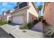 Front exterior of a two-story home with a garage and desert landscaping at 67 Belle Soleil Ave, Las Vegas, NV 89123