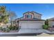 Two-story house with a three-car garage and landscaping at 8217 Quail Arroyo Ave, Las Vegas, NV 89131