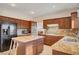 Spacious kitchen with granite countertops, wood cabinets, and island at 8217 Quail Arroyo Ave, Las Vegas, NV 89131