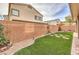 Landscaped backyard with artificial turf and brick pavers at 9113 Sea Mink Ave, Las Vegas, NV 89149