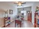 Home office with wood-style flooring, a desk, chair, bookshelves, and a ceiling fan at 9113 Sea Mink Ave, Las Vegas, NV 89149