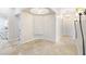 Hallway with tile floors, decorative niche, and laundry room access at 10324 Summit Canyon Dr, Las Vegas, NV 89144