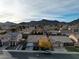 Aerial view of a residential neighborhood showcasing homes with solar panels and mountain views at 1053 Plentywood Pl, Henderson, NV 89002