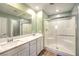 Bathroom with double sinks, white cabinets and a shower at 12 Lomita Heights Dr, Las Vegas, NV 89138