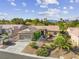 Single-story home with landscaped yard, attached garage, and mountain view at 1461 Bonner Springs Dr, Henderson, NV 89052