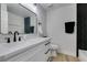 Bathroom with white vanity, black fixtures, and herringbone tile accent wall at 160 Swale Ln, Las Vegas, NV 89144