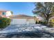 Exterior view of a single-story home with a tiled roof, attached garage, and desert landscaping at 160 Swale Ln, Las Vegas, NV 89144