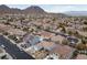 Aerial view of house with pool and solar panels, mountain backdrop at 186 Regal Sunset Ave, Henderson, NV 89002