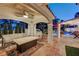 Covered patio with outdoor furniture, fire pit table, and view of the pool and spa at 2848 Cape Verde Ln, Las Vegas, NV 89128