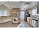 Bright kitchen featuring light wood cabinets, white appliances, and tile flooring at 2925 Wigwam Pkwy # 1124, Henderson, NV 89074