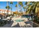 Community pool area with lounge chairs and palm trees at 2925 Wigwam Pkwy # 1124, Henderson, NV 89074