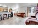 Living room with brown couches, tiled floor, and a view into the kitchen and dining areas at 2983 Juniper Hills Blvd # 102, Las Vegas, NV 89142