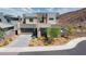 Modern two-story home with a gray facade, attached garage, and landscaped yard at 318 Shaded Canyon Dr, Henderson, NV 89012