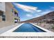 Long rectangular pool with a modern design and mountain backdrop at 318 Shaded Canyon Dr, Henderson, NV 89012