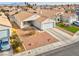 High-angle view of a single-story house with a two-car garage, landscaping, and driveway at 3618 Glacier Grove Dr, North Las Vegas, NV 89032