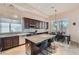 Modern kitchen with island, stainless steel appliances, dark wood cabinets, and breakfast nook at 4729 Dream Catcher Ave, Las Vegas, NV 89129