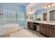 Modern bathroom with double vanity, soaking tub, and glass-enclosed shower at 4729 Dream Catcher Ave, Las Vegas, NV 89129