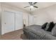 Well-lit bedroom with ceiling fan, carpet, and mirrored closet doors at 65 Clayton St, Las Vegas, NV 89110