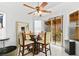 Dining area with a glass-top table, ceiling fan, and sliding glass doors to the backyard at 6653 Lund Dr, Las Vegas, NV 89108