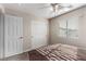 Bedroom featuring ceiling fan, carpeted floors, closet, and window with blinds at 8331 Lower Trailhead Ave, Las Vegas, NV 89113