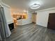 Living room with fireplace, wood-look floors, and open view to kitchen at 8501 W University Ave # 1126, Las Vegas, NV 89147