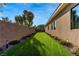 Long strip of green lawn along side of house, perfect yard at 102 Appia Pl, Henderson, NV 89011