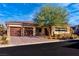 Single-story home with brown double garage doors and desert landscaping at 102 Appia Pl, Henderson, NV 89011