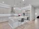 Bright, spacious kitchen featuring stainless steel appliances, white shaker cabinets, and an oversized island at 102 Appia Pl, Henderson, NV 89011