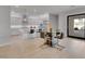 Open-concept kitchen and dining area with sleek finishes, stainless steel appliances and a glass table at 102 Appia Pl, Henderson, NV 89011