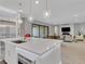 Modern kitchen with white countertops, stainless steel appliances, and open floor plan at 102 Appia Pl, Henderson, NV 89011