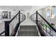 Upstairs hallway with sleek black railing and modern light fixtures at 10748 Steel Ridge Ct, Las Vegas, NV 89135